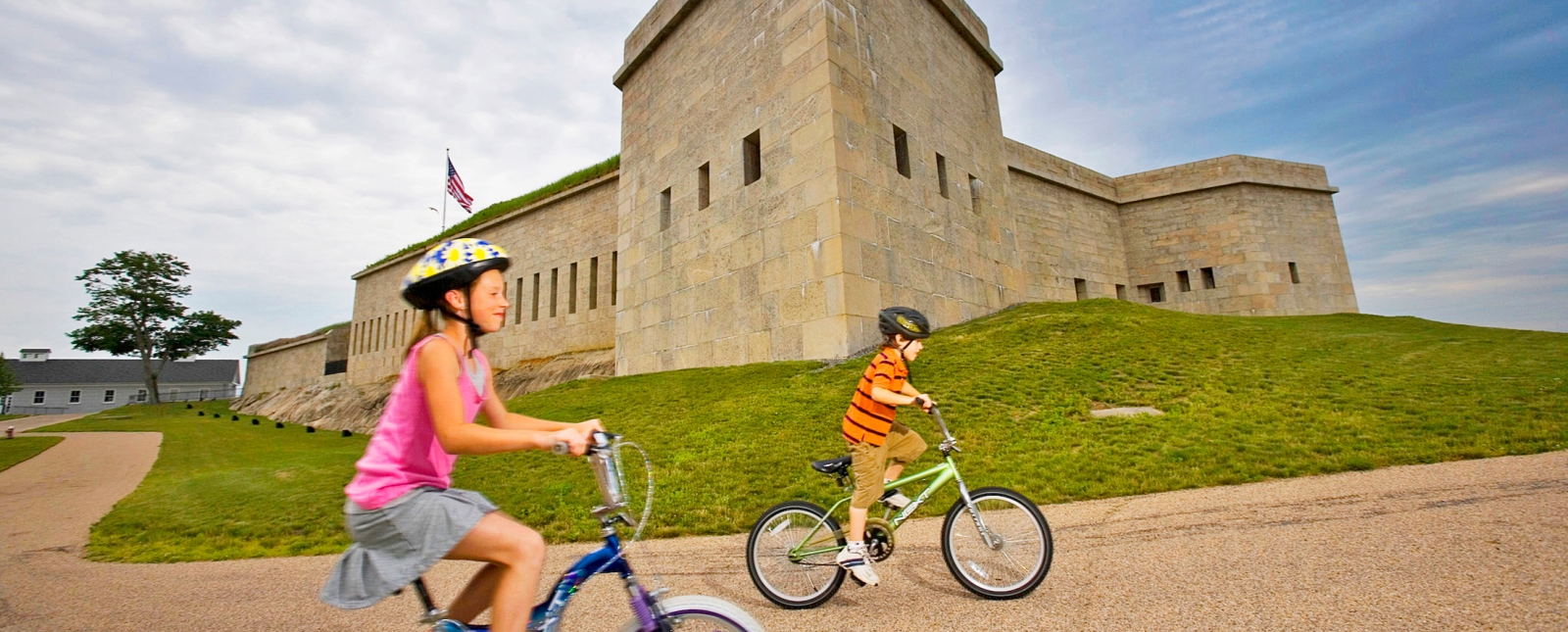 Kids bike riding outside path of Fort Trumbull State Park