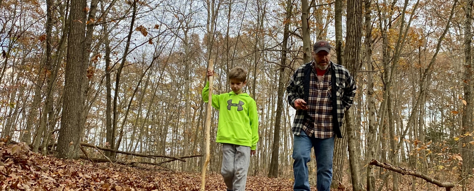 Adult man and young boy walking on a trail