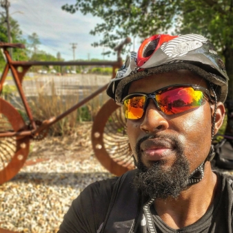 A man biking in front of bike sculpture (Instagram@btl_85)