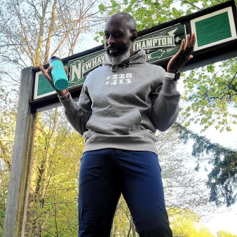 A man standing in front of sign (Instagram@whereareyourfromapparel)