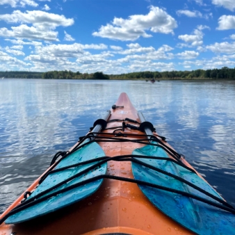 a kayak on the water with sky and clouds (Instagram@ddtnewengland)