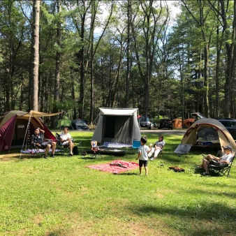 A family sitting at a campsite in the summer (Instagram@inouehd)