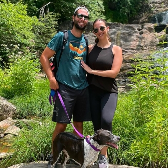 Couple with their dog in front of the falls at Kent Falls (Instagram@g_smittys)