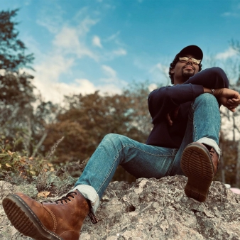 A man posing for a photo while on a hike (Instagram@richwich07)