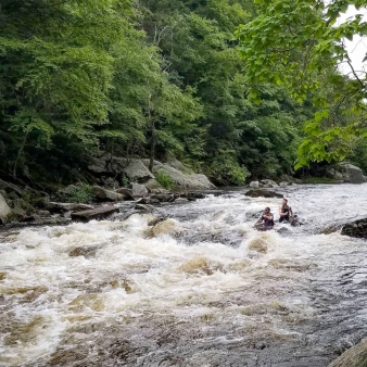 Two men on a canoe in the rapids (Instagram@ben_krez)