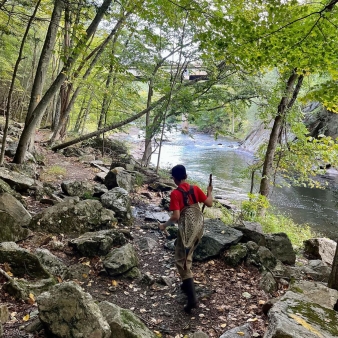 A boy walking through the woods on his way to go fishing (Instagram@daleman_outside)