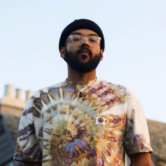 Man posing portrait in front of Topsmead (Instagram@51glasshouseeve)