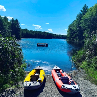 Two colorful kayaks resting on the water's edge, ready for an adventure.